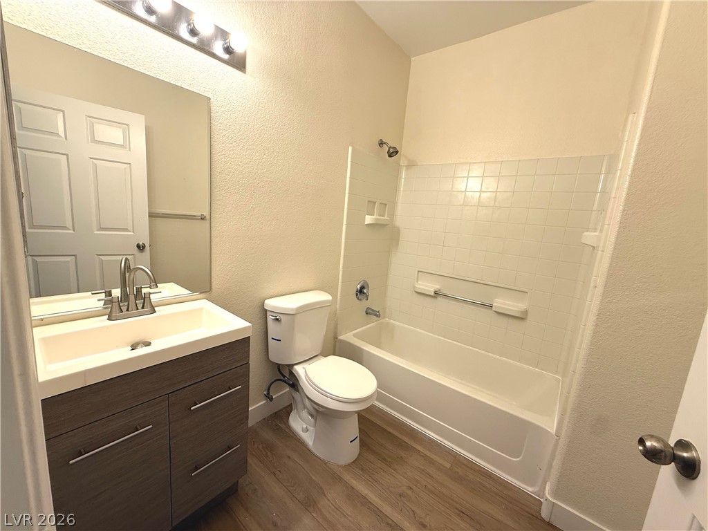 4730 East Craig Road, Unit 1164 Las Vegas, NV 89115 - Photo 7 of 14 A well-appointed bathroom offers a convenient vanity, a full bathtub, and elegant wood-style flooring.