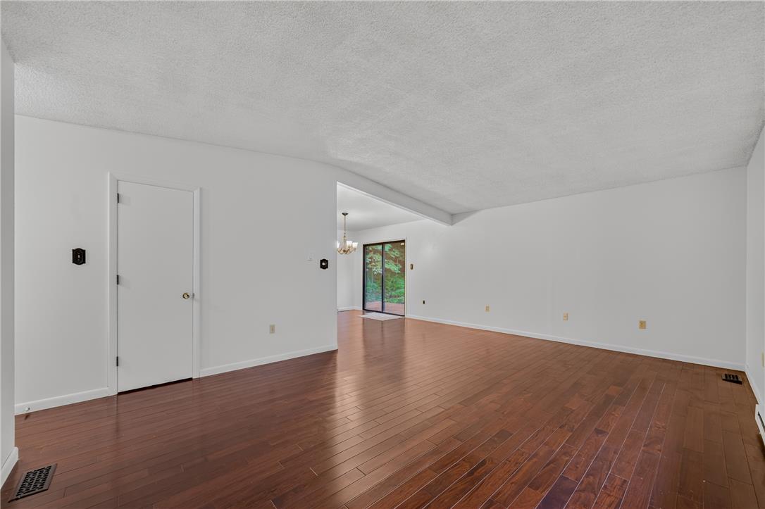 1570 Astolat Road Effort, PA 18330 - Photo 17 of 48 Rich hardwood floors sweep through this expansive, light-filled open concept living area.