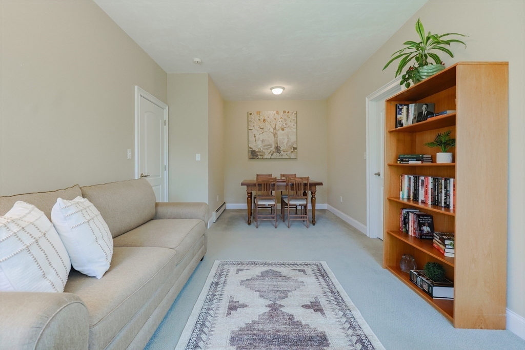 4 Berkeley Drive Walpole, MA 02081 - Photo 15 of 42 a living room with furniture and a book shelf