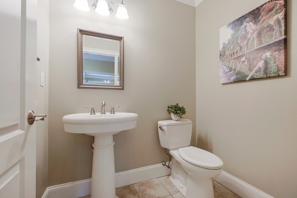 4 Berkeley Drive Walpole, MA 02081 - Photo 17 of 42 a bathroom with a toilet sink and mirror
