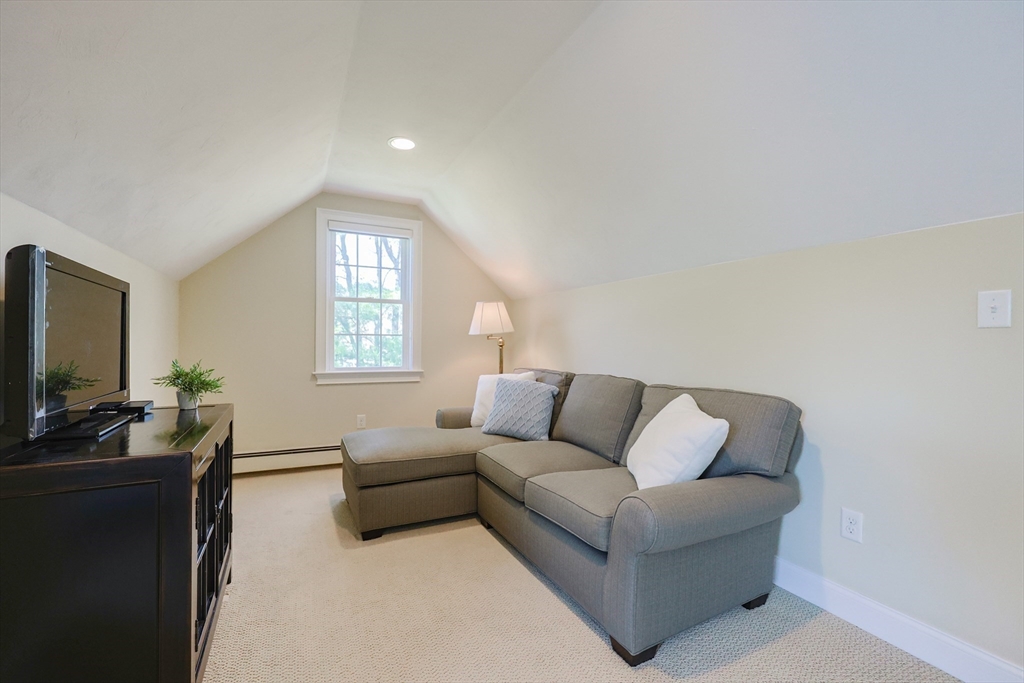 4 Berkeley Drive Walpole, MA 02081 - Photo 23 of 42 a living room with furniture and a flat screen tv