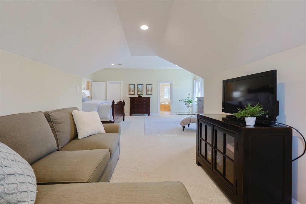 4 Berkeley Drive Walpole, MA 02081 - Photo 24 of 42 a living room with furniture and a flat screen tv