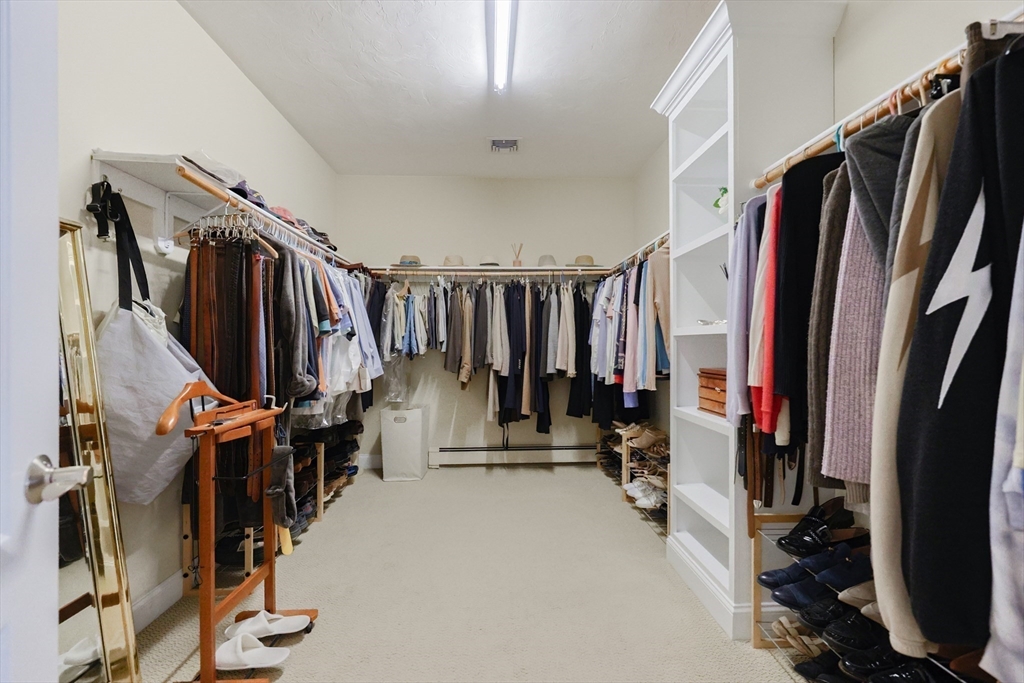 4 Berkeley Drive Walpole, MA 02081 - Photo 27 of 42 a view of walk in closet with clothes