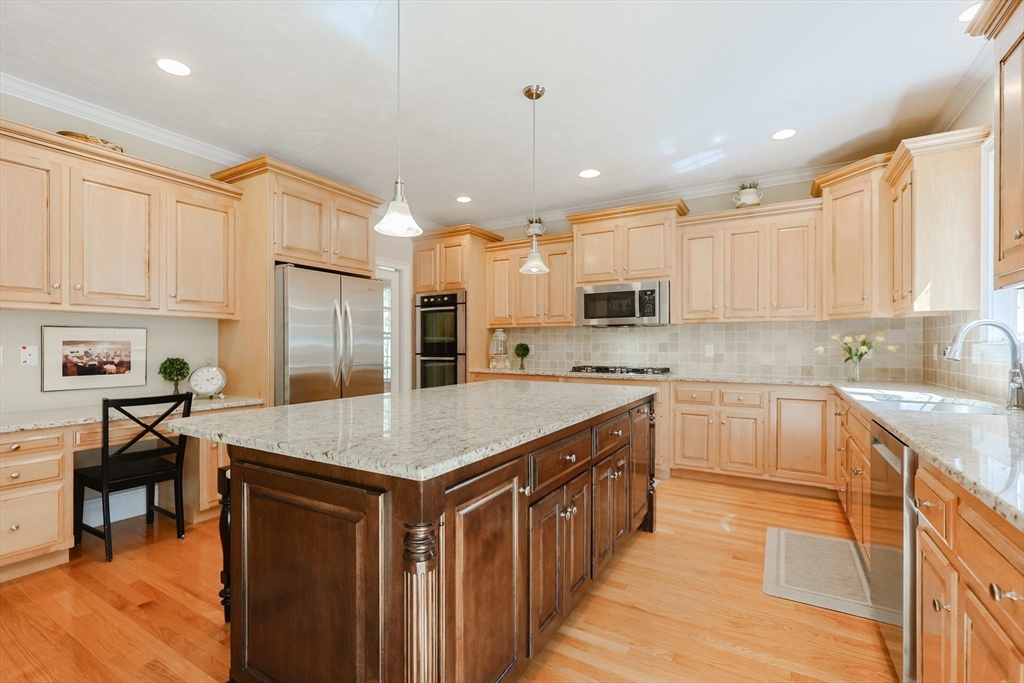 4 Berkeley Drive Walpole, MA 02081 - Photo 3 of 42 a kitchen with stainless steel appliances granite countertop a stove top oven a sink dishwasher and a refrigerator with wooden floor