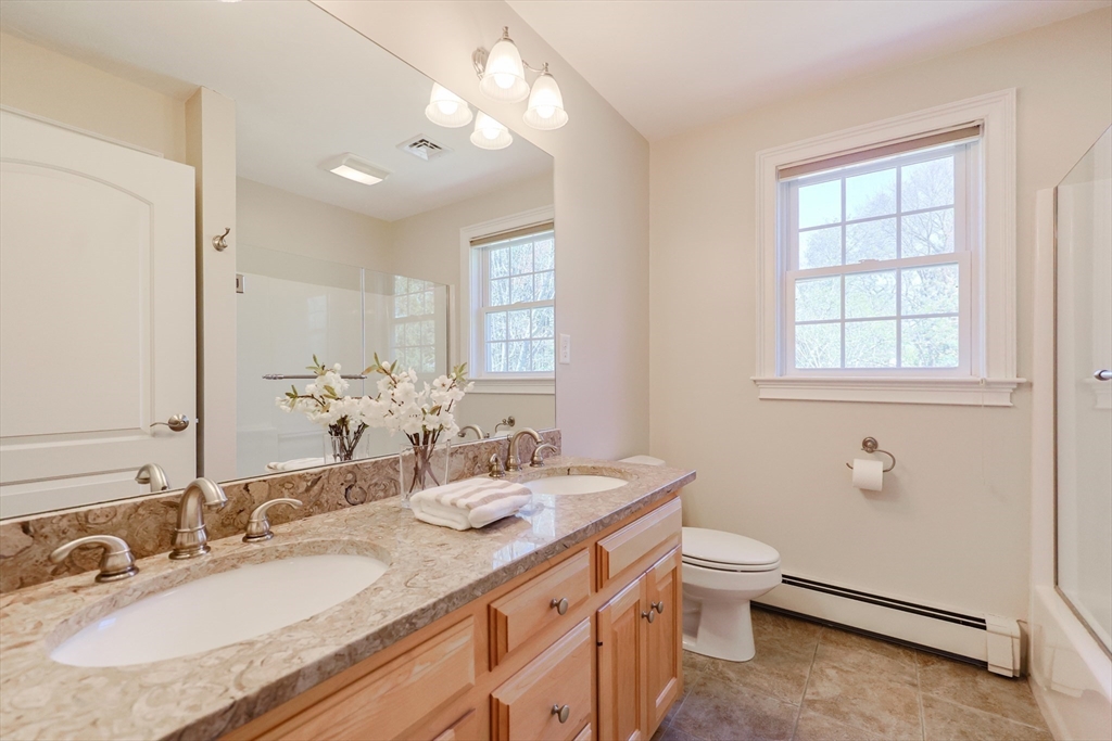 4 Berkeley Drive Walpole, MA 02081 - Photo 32 of 42 a bathroom with a granite countertop double vanity sink a mirror and a toilet