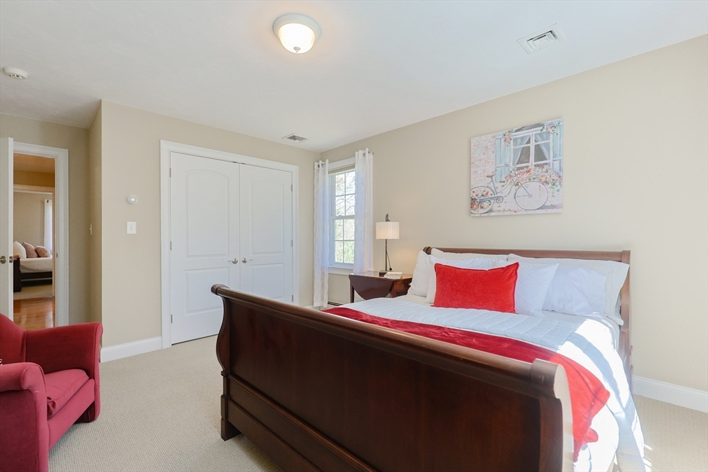 4 Berkeley Drive Walpole, MA 02081 - Photo 35 of 42 a bedroom with a bed and a potted plant