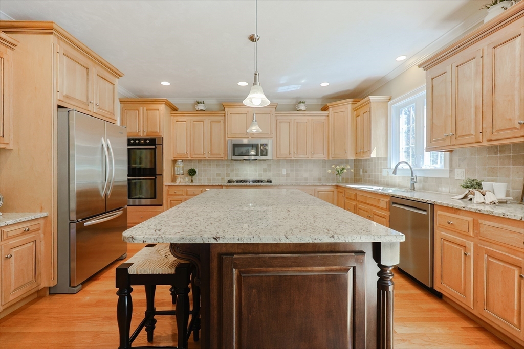 4 Berkeley Drive Walpole, MA 02081 - Photo 5 of 42 a kitchen with kitchen island a refrigerator a sink and white cabinets