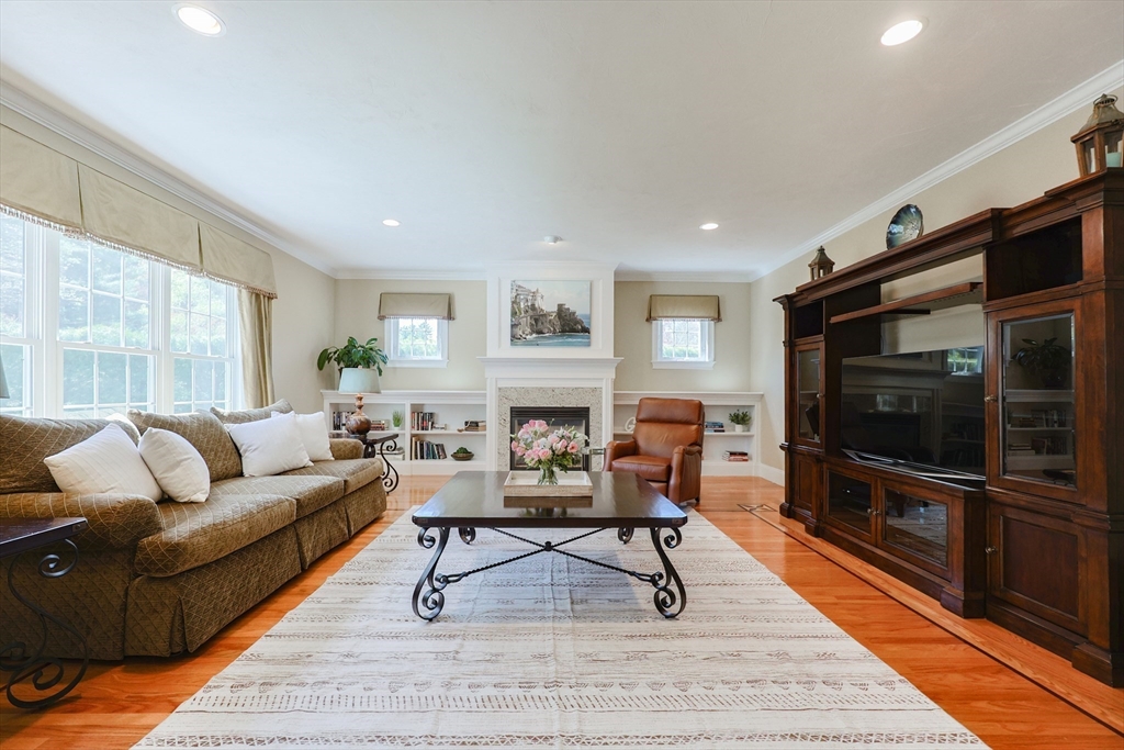 4 Berkeley Drive Walpole, MA 02081 - Photo 7 of 42 a living room with furniture a rug and a flat screen tv