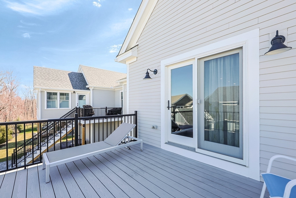 13 Birkdale Lane, Unit 13 Hopkinton, MA 01748 - Photo 21 of 27 a view of a balcony with furniture and wooden floor