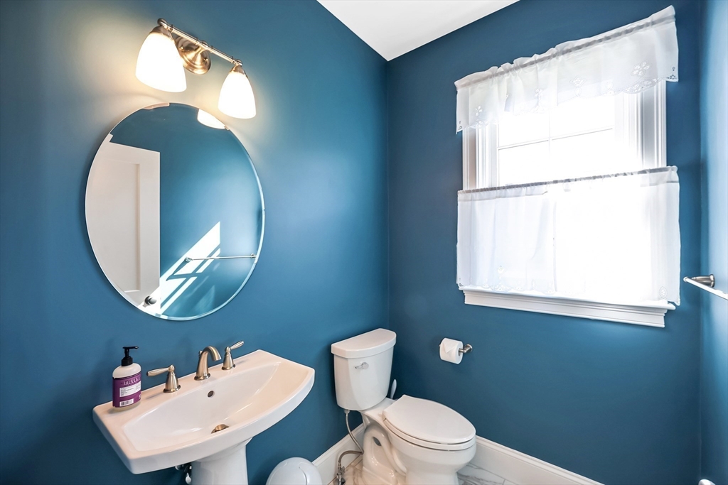 13 Birkdale Lane, Unit 13 Hopkinton, MA 01748 - Photo 7 of 27 a bathroom with a toilet a sink and a mirror