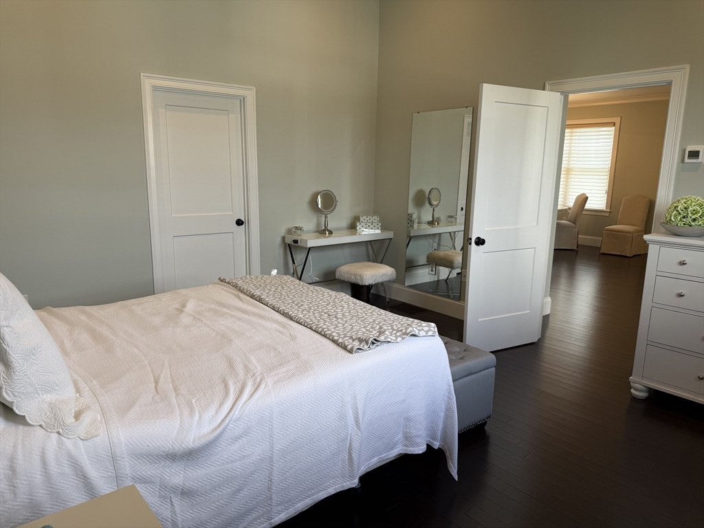 13 Birkdale Lane, Unit 13 Hopkinton, MA 01748 - Photo 9 of 27 a bedroom with a bed and a mirror