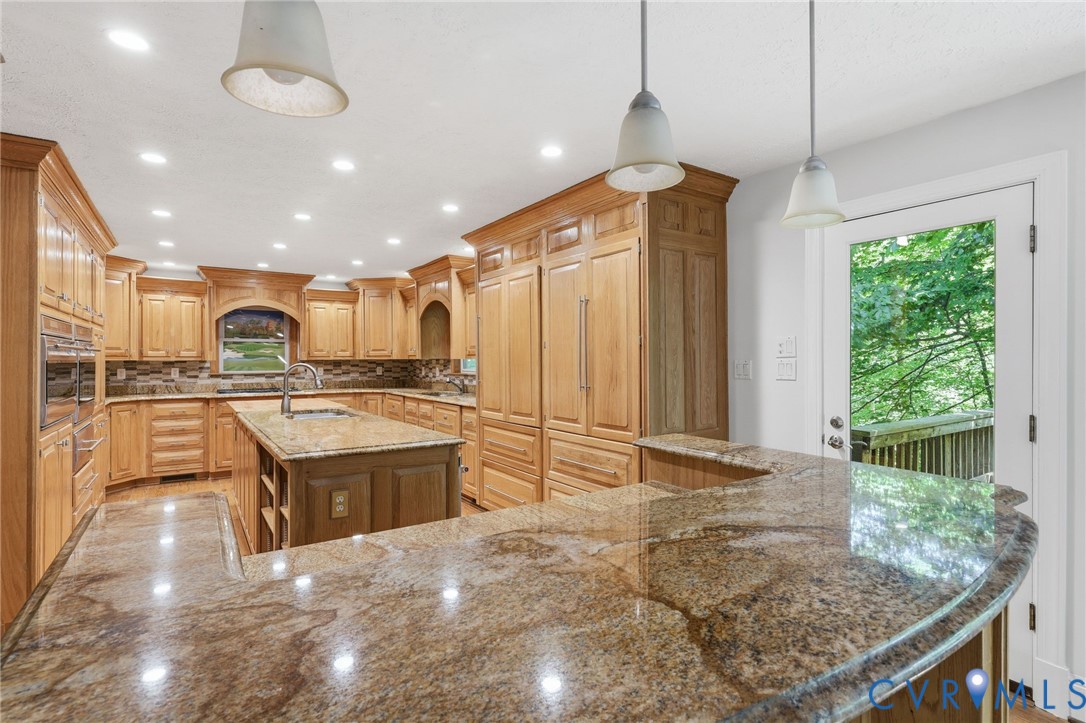 3201 East Brigstock Road Midlothian, VA 23113 - Photo 15 of 72 a large kitchen with kitchen island a sink a counter top stainless steel appliances and cabinets