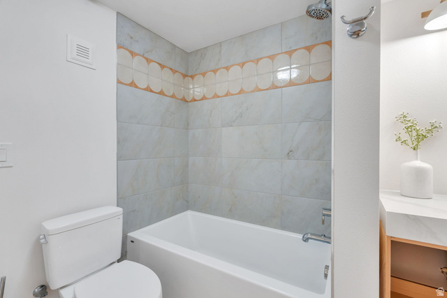 3813 North Foothill Drive Provo, UT 84604 - Photo 44 of 71 Tiled bath and shower combination with a decorative accent band and integrated shower head