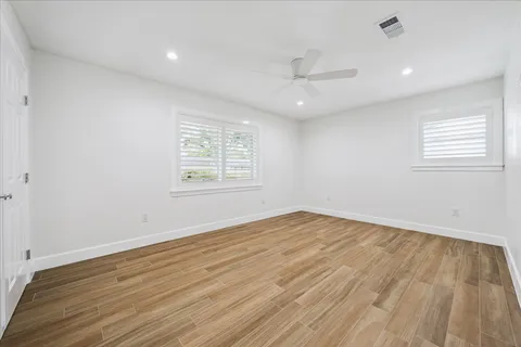 a bathroom with a granite countertop sink a mirror a shower and a bathtub