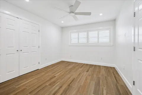 a bathroom with a granite countertop sink a toilet and a large mirror