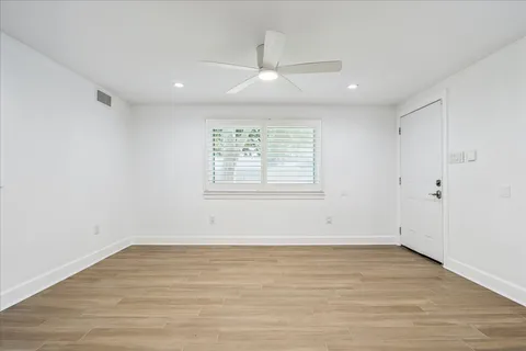 a bathroom with a granite countertop sink a toilet and shower
