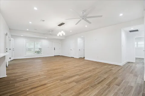 a view of a room with wooden floor