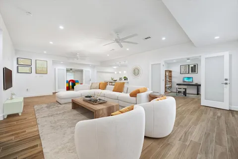 a view of empty room with wooden floor and window