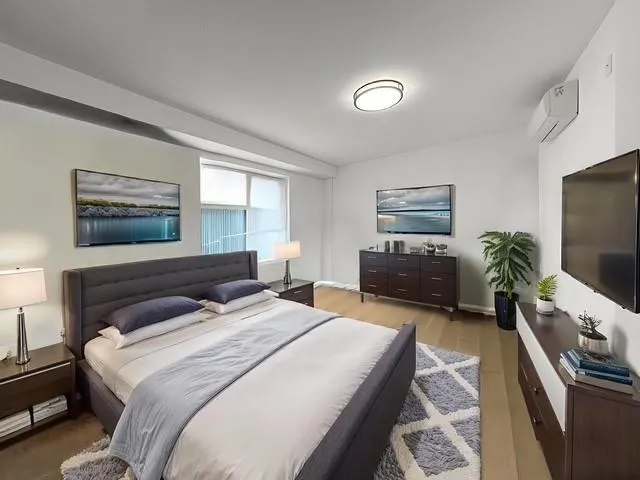 a bedroom with a bed and a television