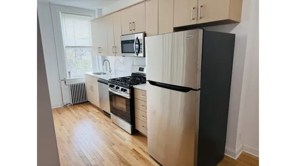 a kitchen with stainless steel appliances a refrigerator stove and microwave