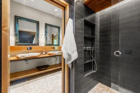 a bathroom with a tub mirror and sink