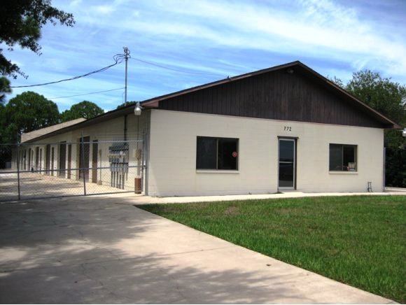 772 Washburn Road, Unit B Melbourne, FL 32934 - Photo 3 of 5 a front view of a house with a garden