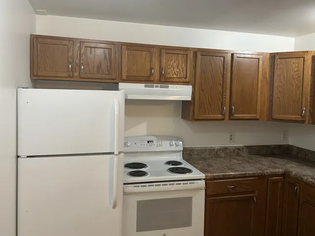 a kitchen with a stove top oven and cabinets