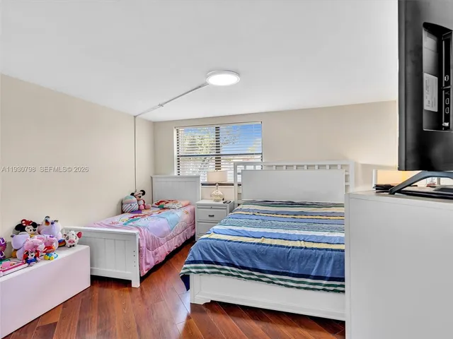 a bedroom with bed and window