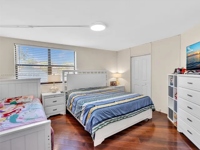 a bedroom with a bed and a dresser in it