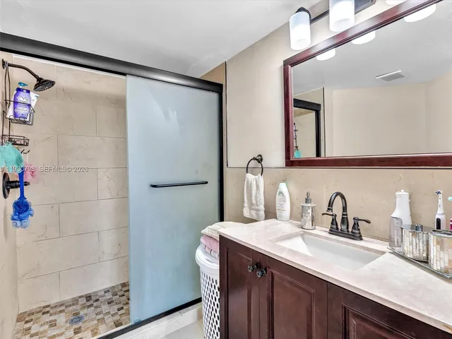 a bathroom with a double vanity sink and mirror