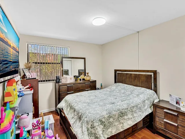 a bedroom with a bed and dresser