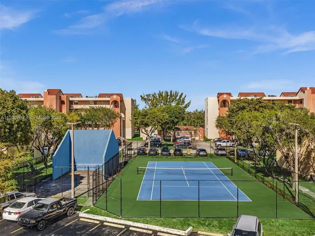 an aerial view of ocean and residential houses with outdoor space