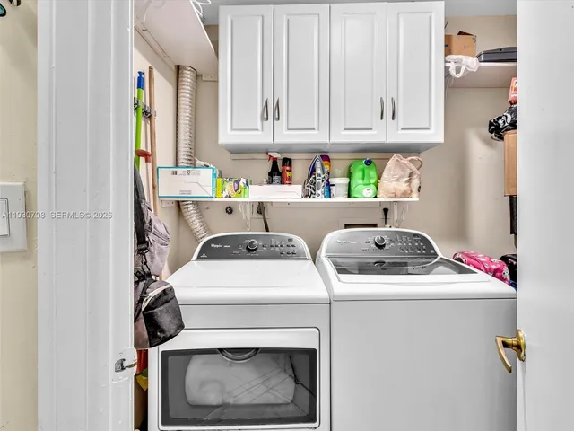 a utility room with dryer washer and a refrigerator