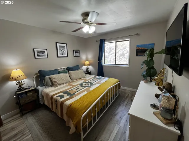 a bed room with a bed and a flat tv screen on a dresser