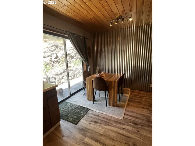 a dining room with furniture and wooden floor