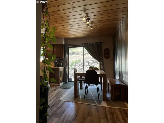 a dining room with furniture and wooden floor