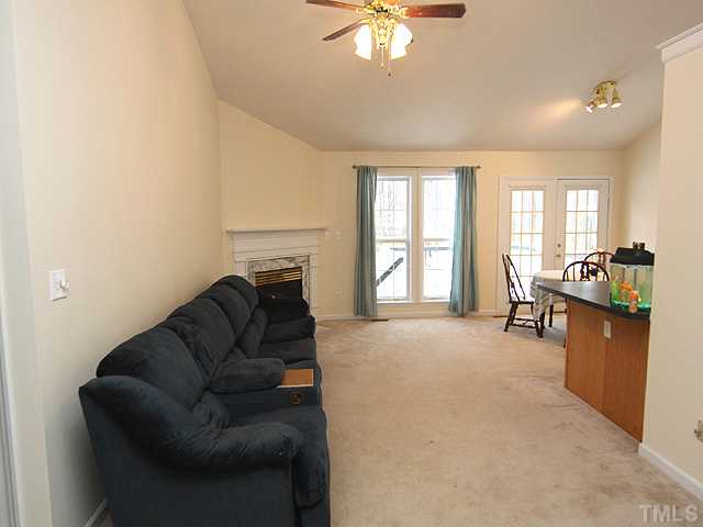 2005 Brightwell Lane Raleigh, NC 27610 - Photo 3 of 12 Lving Room features gas log fireplace in corner, is open to the dining room and kitchen, and overlooks the back yard.