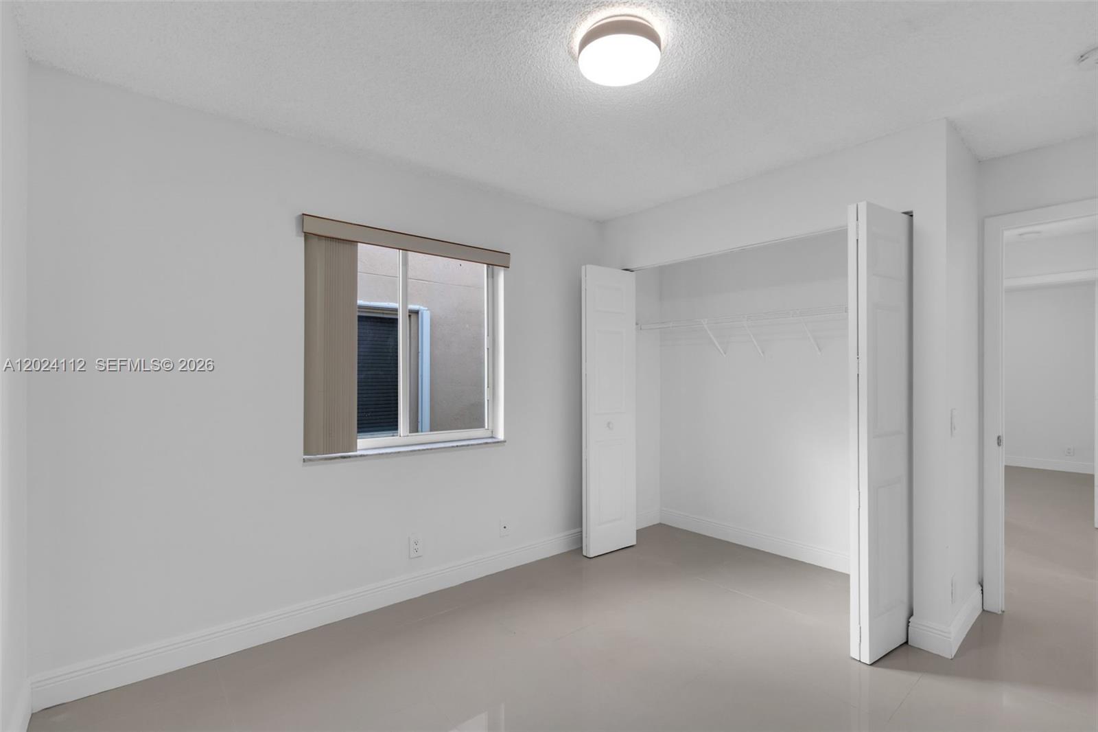 4366 Mahogany Ridge Drive Weston, FL 33331 - Photo 17 of 41 an empty room with windows and closet
