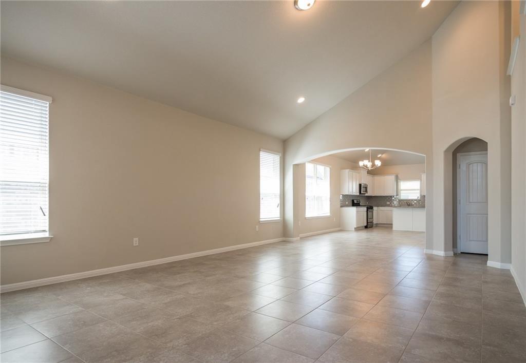 641 Schefer Street Leander, TX 78641 - Photo 4 of 17 Spacious living area featuring vaulted ceilings, recessed lighting, and large format tile flooring