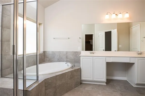 a bathroom with a bathtub and a sink