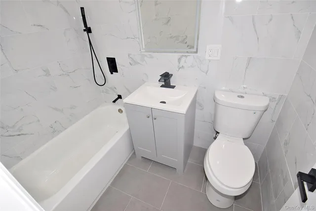 a bathroom with a sink a toilet and a bathtub