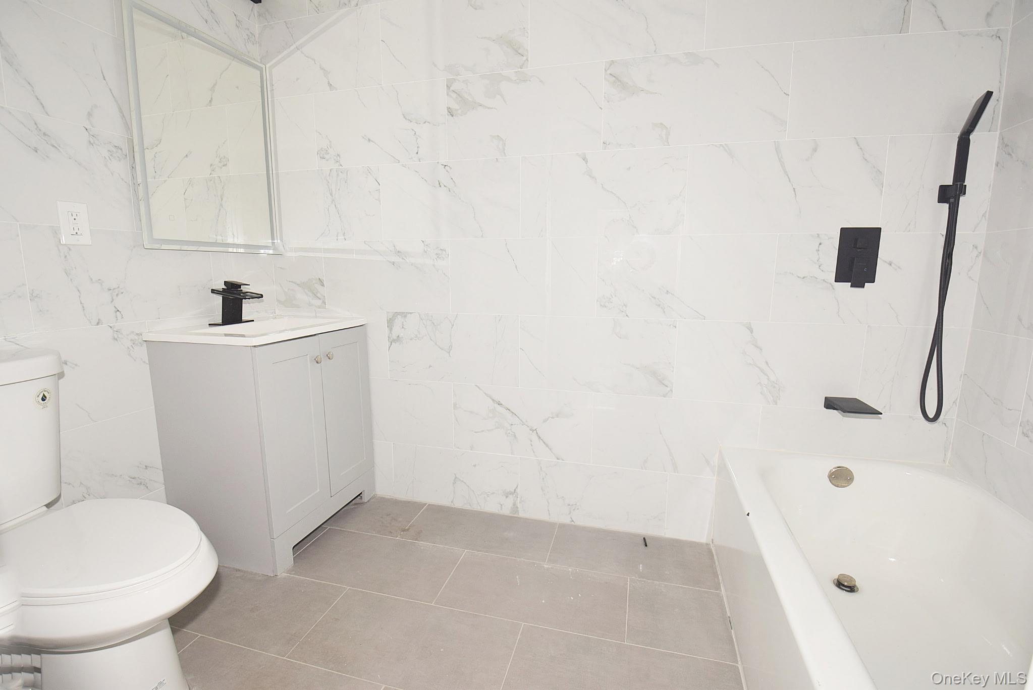 155-20 Tuskegee Airmen Way Queens, NY 11433 - Photo 9 of 13 a bathroom with a sink a toilet and shower