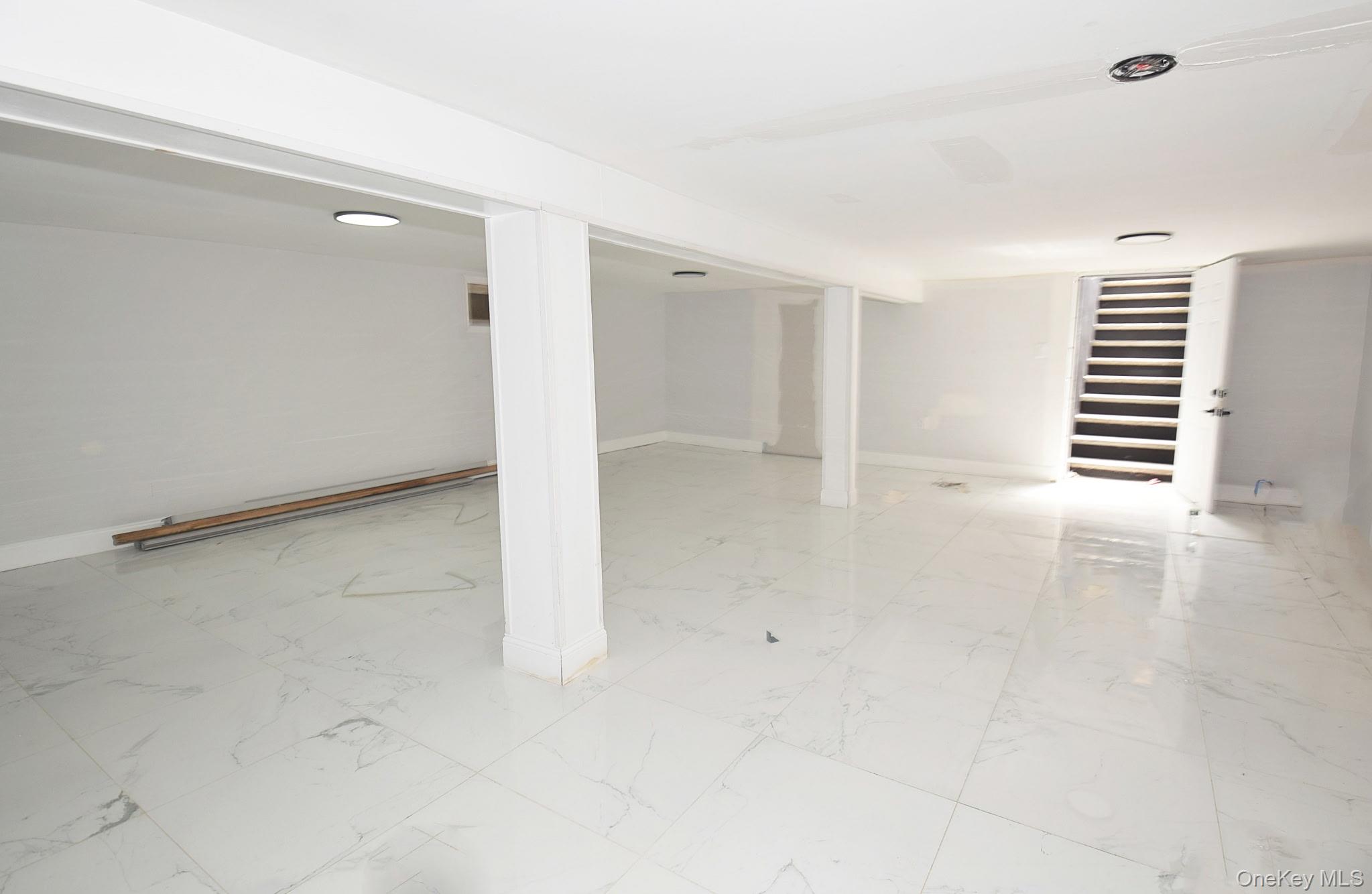155-20 Tuskegee Airmen Way Queens, NY 11433 - Photo 10 of 13 an empty room with windows and pillars in it