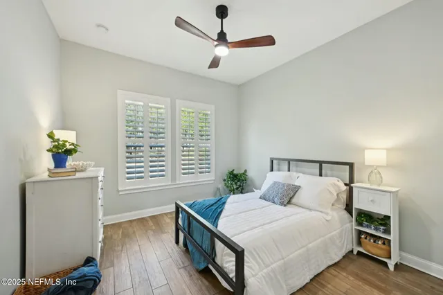 a living room with furniture kitchen area and a large window