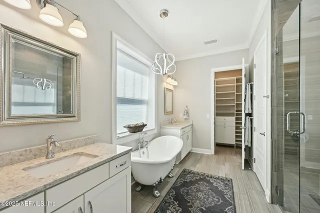 a bedroom with a bed a dresser next to a window