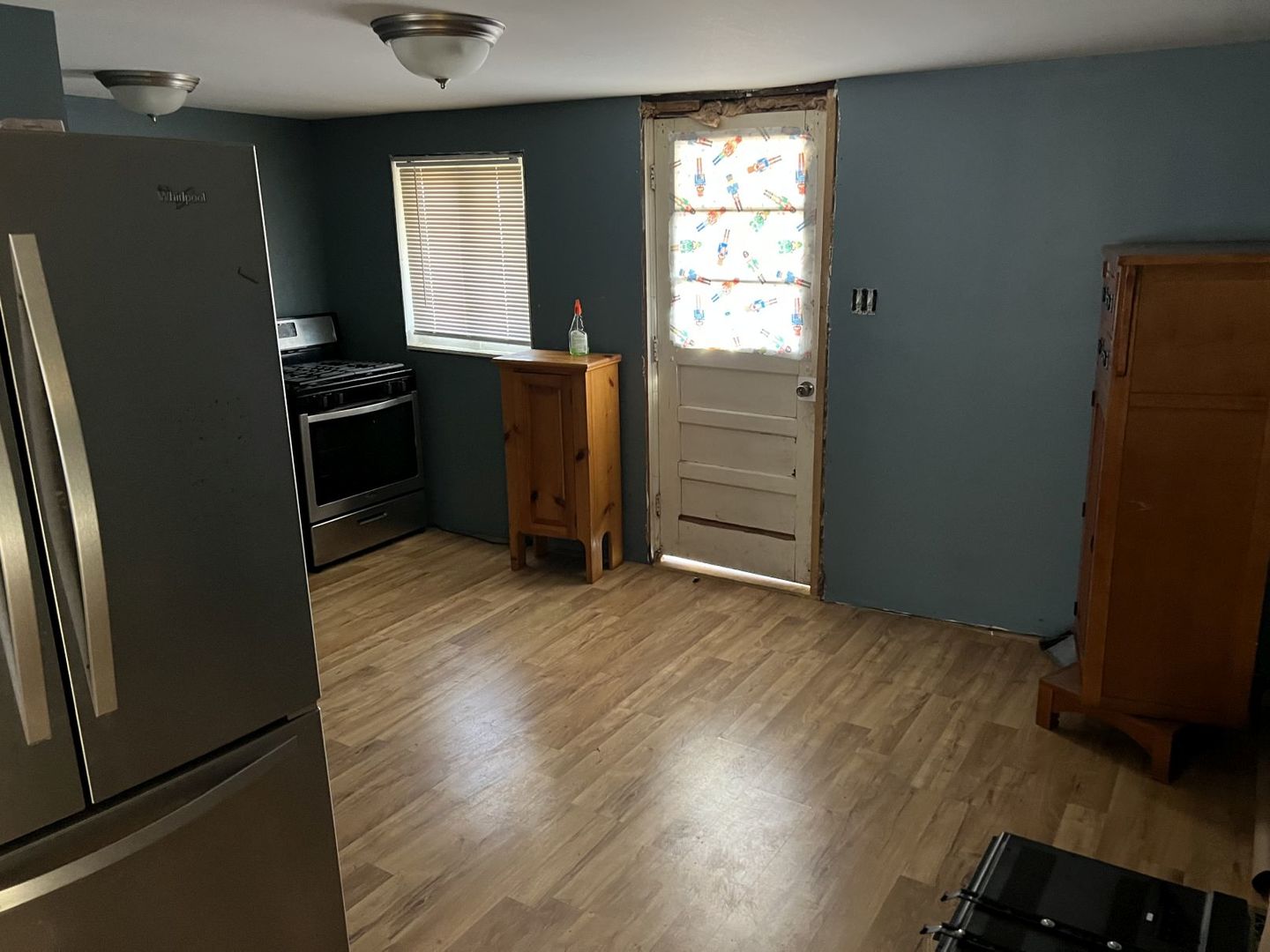 405 West Bissell Street Bloomington, IL 61701 - Photo 7 of 21 an empty room with wooden floor cabinets and windows