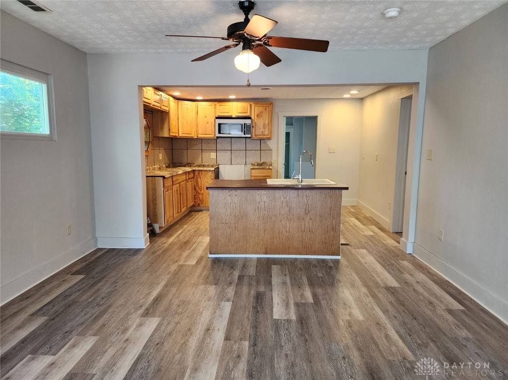 211 Race Street Spring Valley, OH 45370 - Photo 2 of 12 This inviting kitchen with a central island and a ceiling fan is perfect for culinary endeavors.