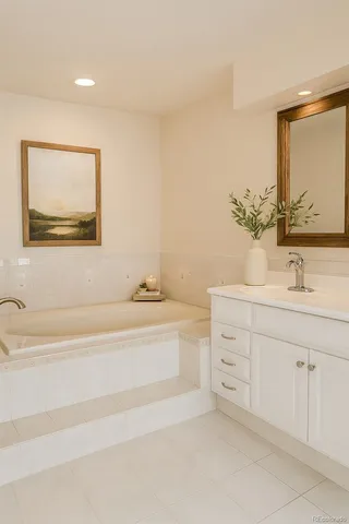 a spacious bathroom with a double vanity sink mirror and bathtub