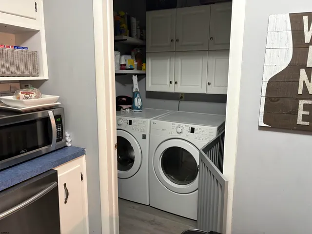 a view of a kitchen with washer and dryer