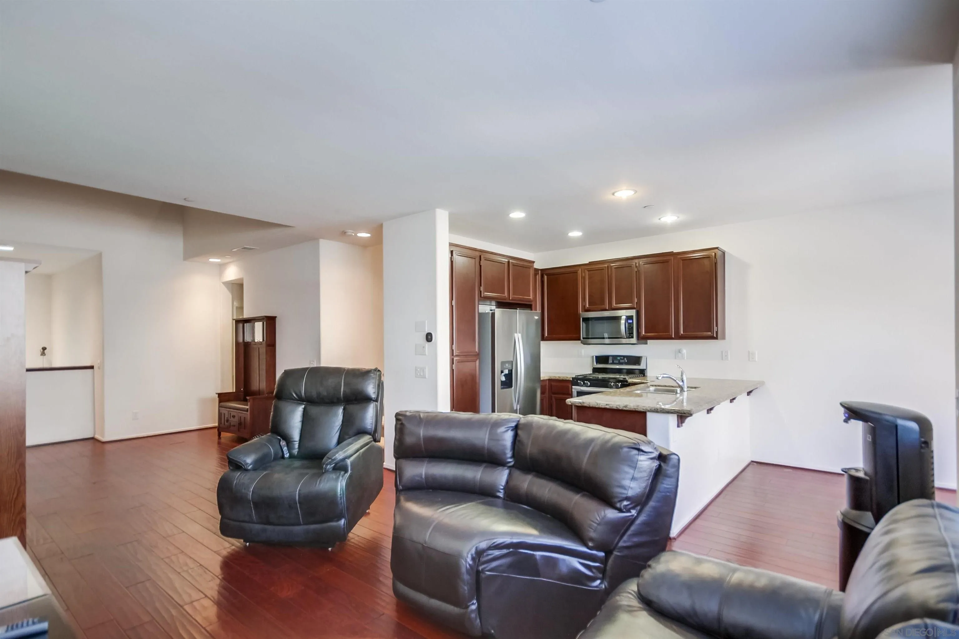 9810 Old Tree Lane Santee, CA 92071 - Photo 11 of 37 a living room with furniture and a view of kitchen